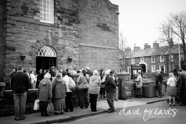 Onlookers wait outside St Mary's Church for the Bride and Groom