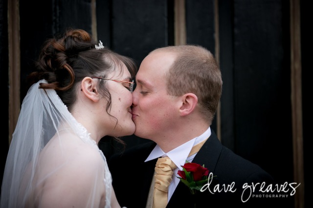 Bride and Groom kiss outside church