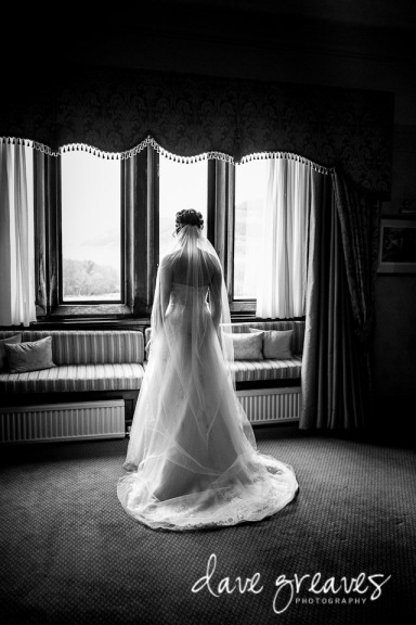 Bridal portrait standing by the window at Armathwaite Hall