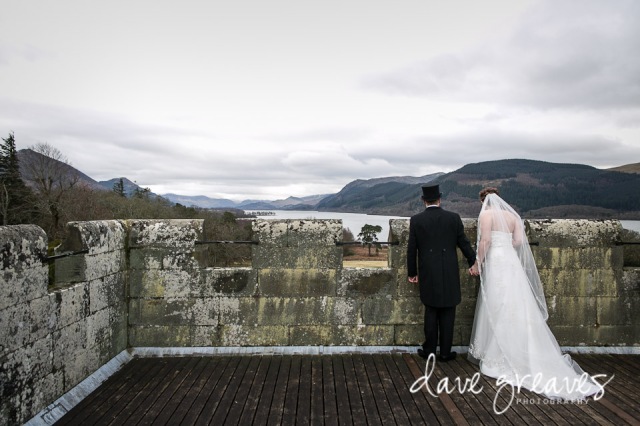 Bride and Groom on the roof of Armathwaite Hall looking at the view across Bassenthwaite Lake