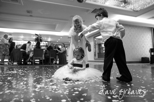 Young guests shower confetti over flower girl