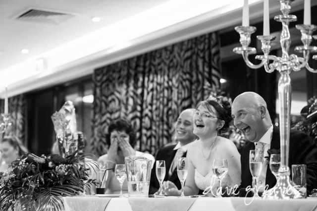 Top table laughing during wedding speeches