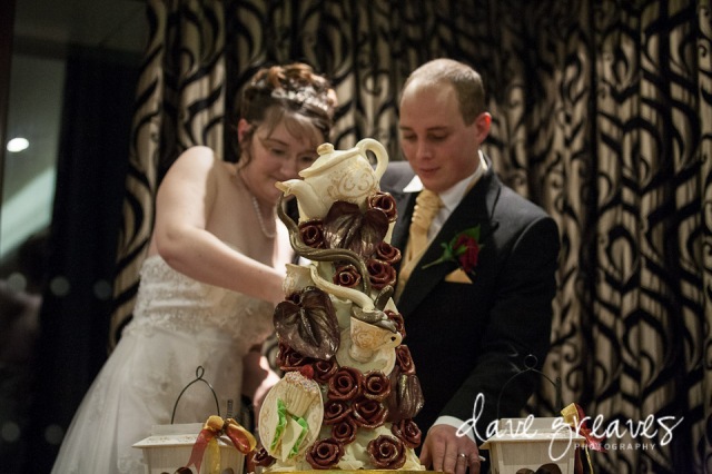 Bride and Groom cutting tea party wedding cake by choccywoccydoodah