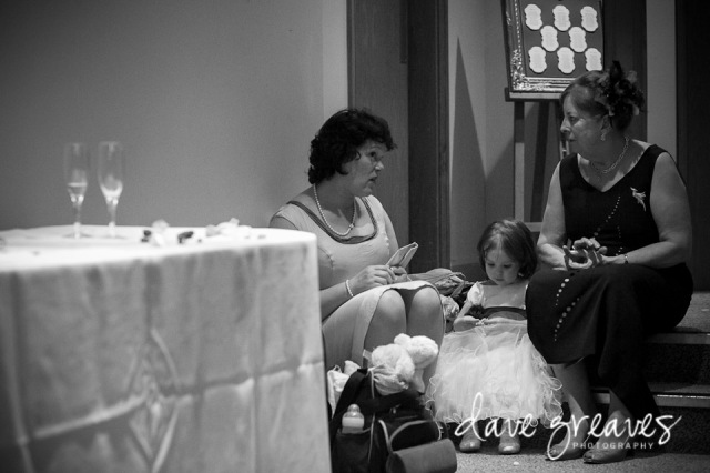 Special moment captured as mothers sit on a step with the flower girl