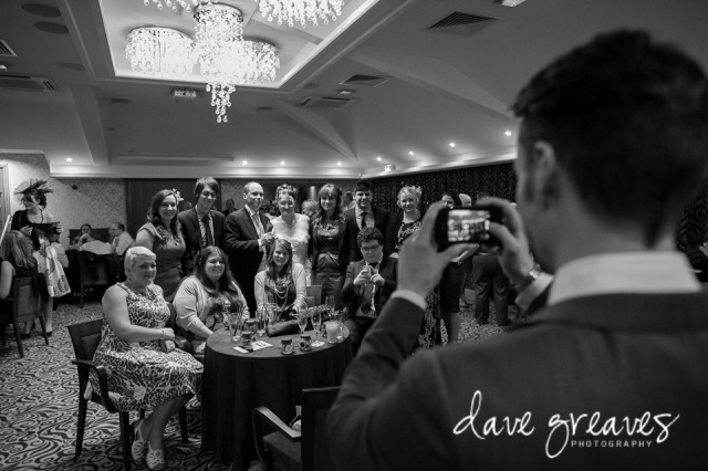 Wedding guest takes a picture of bride and friends